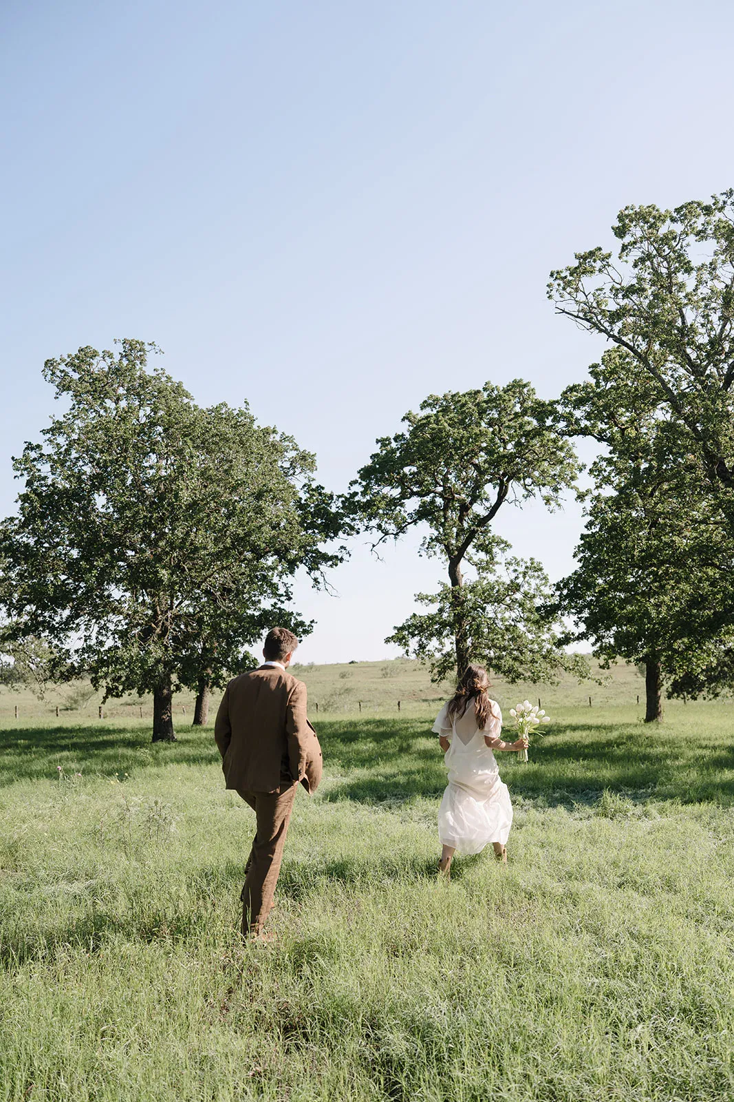 Couple walking through the open prairie at Serana