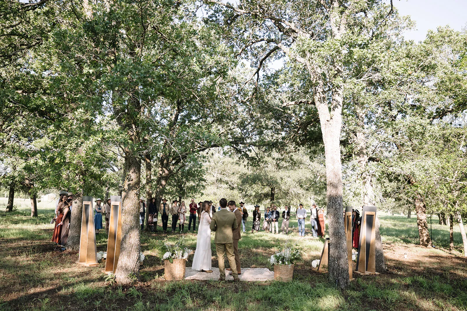 Intimate wedding ceremony beneath oak trees at Serana