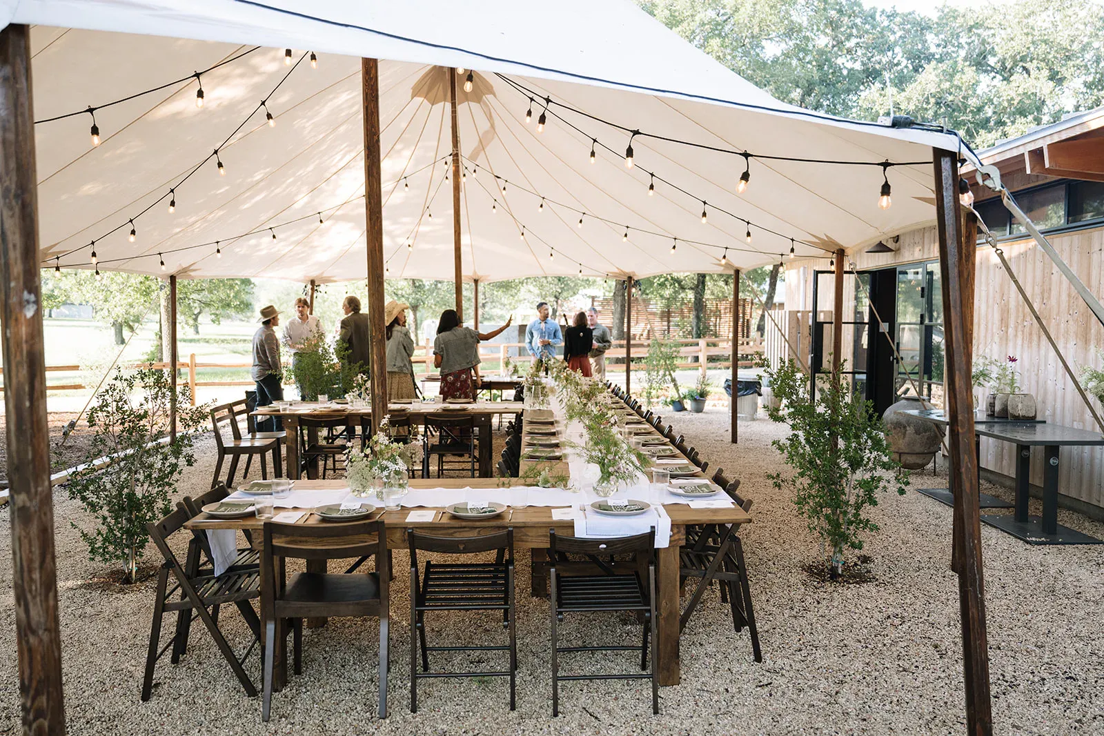 Open-air welcome dinner set beneath a sailcloth tent at Serana