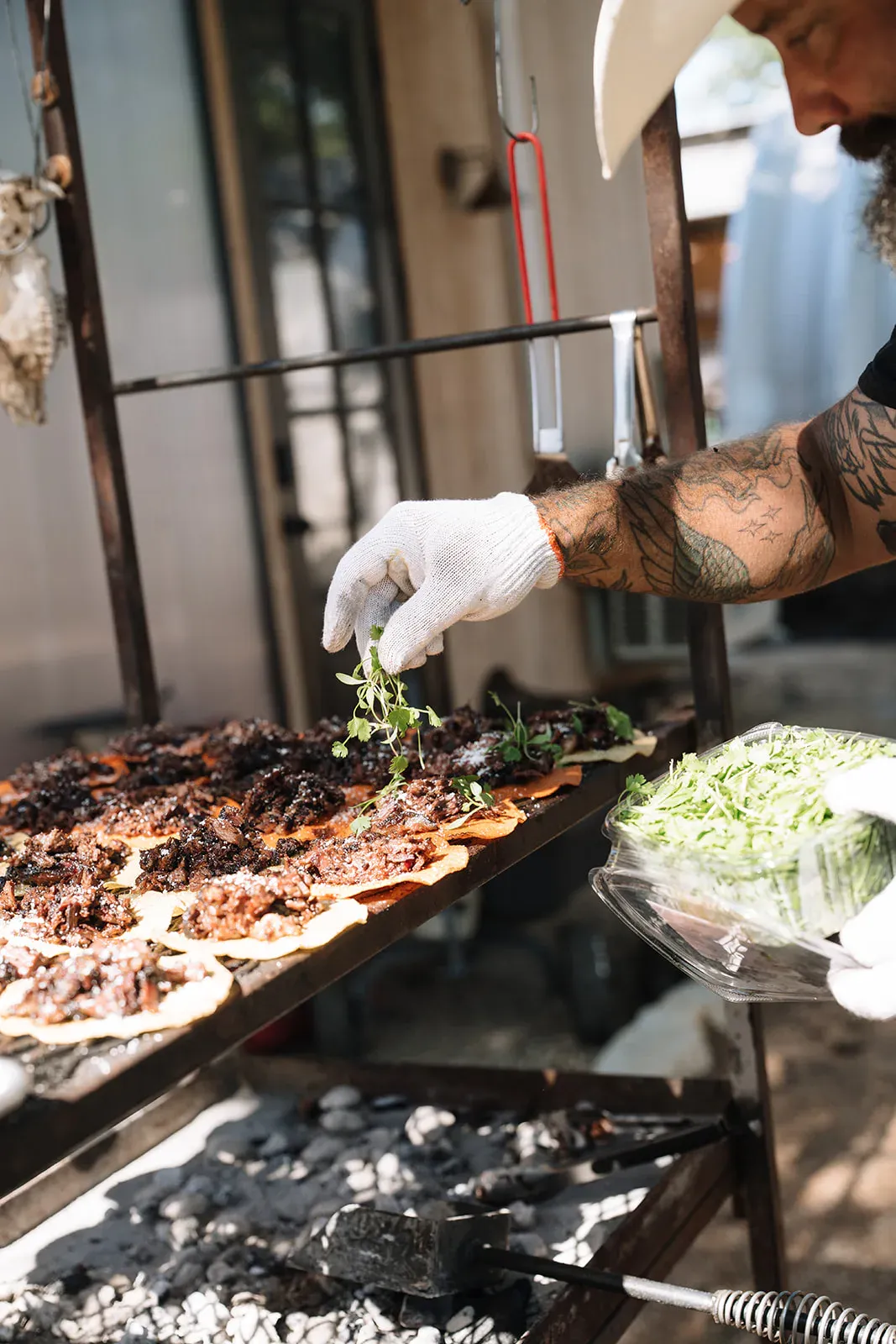 Chef garnishing open-flame food for a Serana dinner
