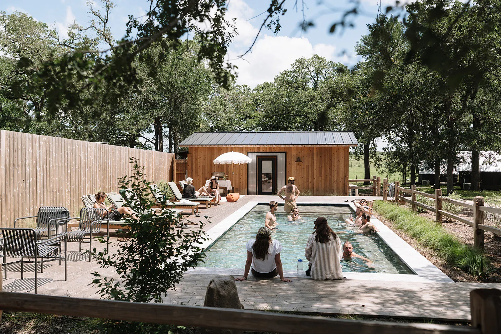 Guests swimming at the Serana pool house