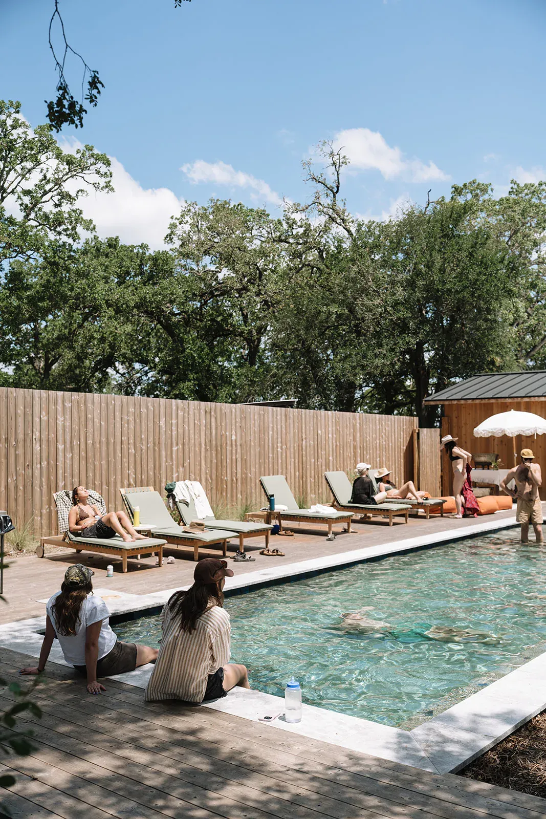Guests gathered beside the Serana pool during a retreat