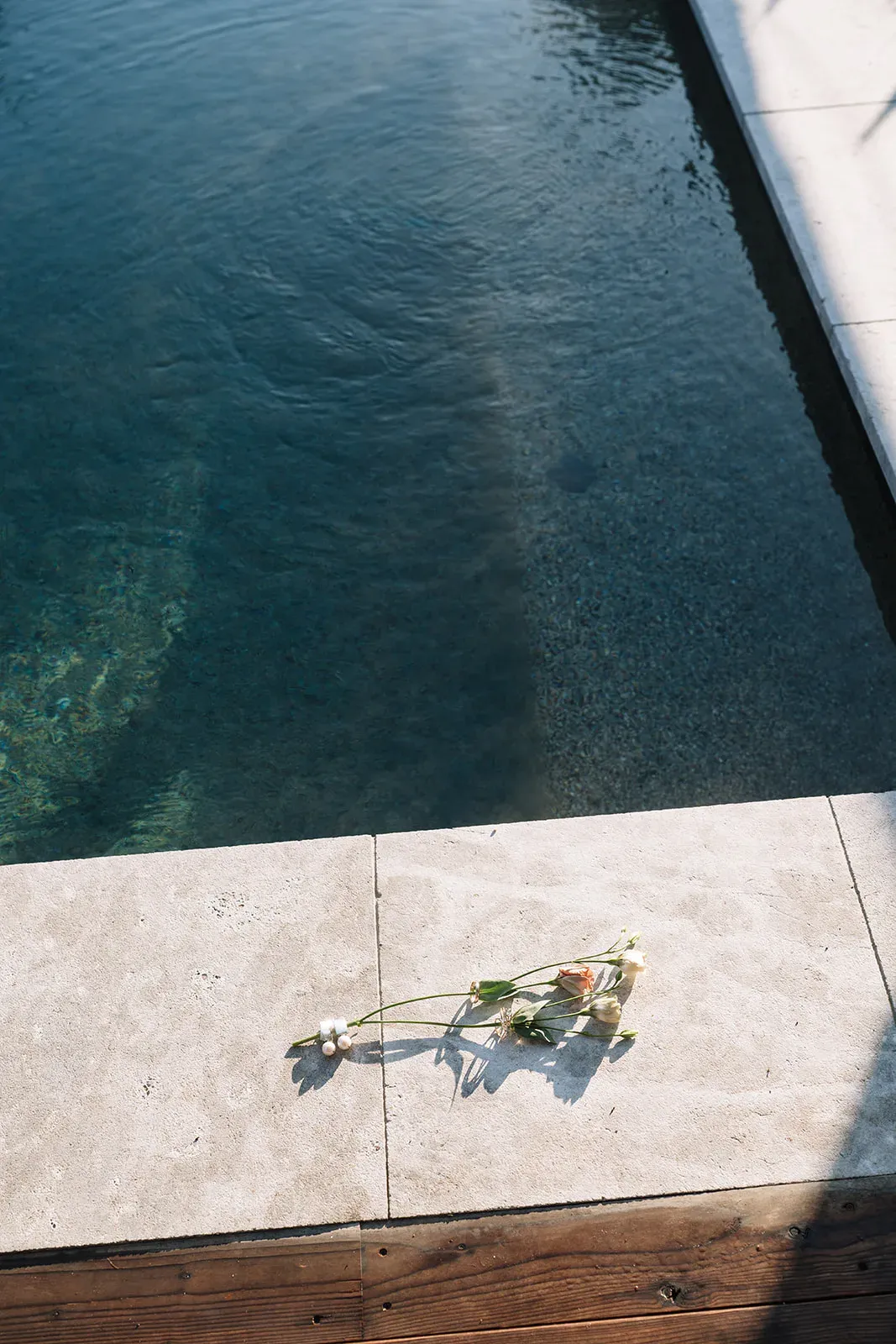 Wedding detail on stone beside the Serana saltwater pool