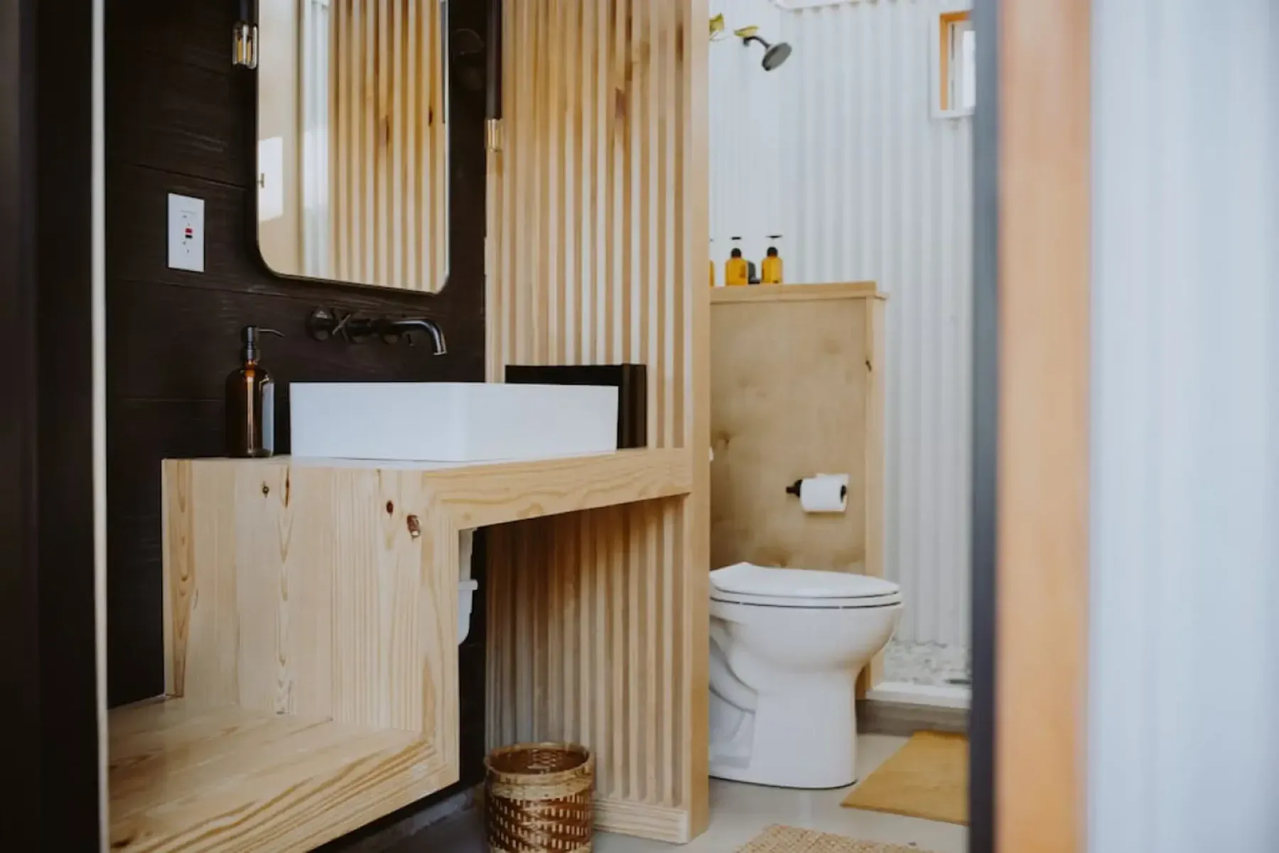 Cabin bathroom shower and vanity inside a Serana guest stay