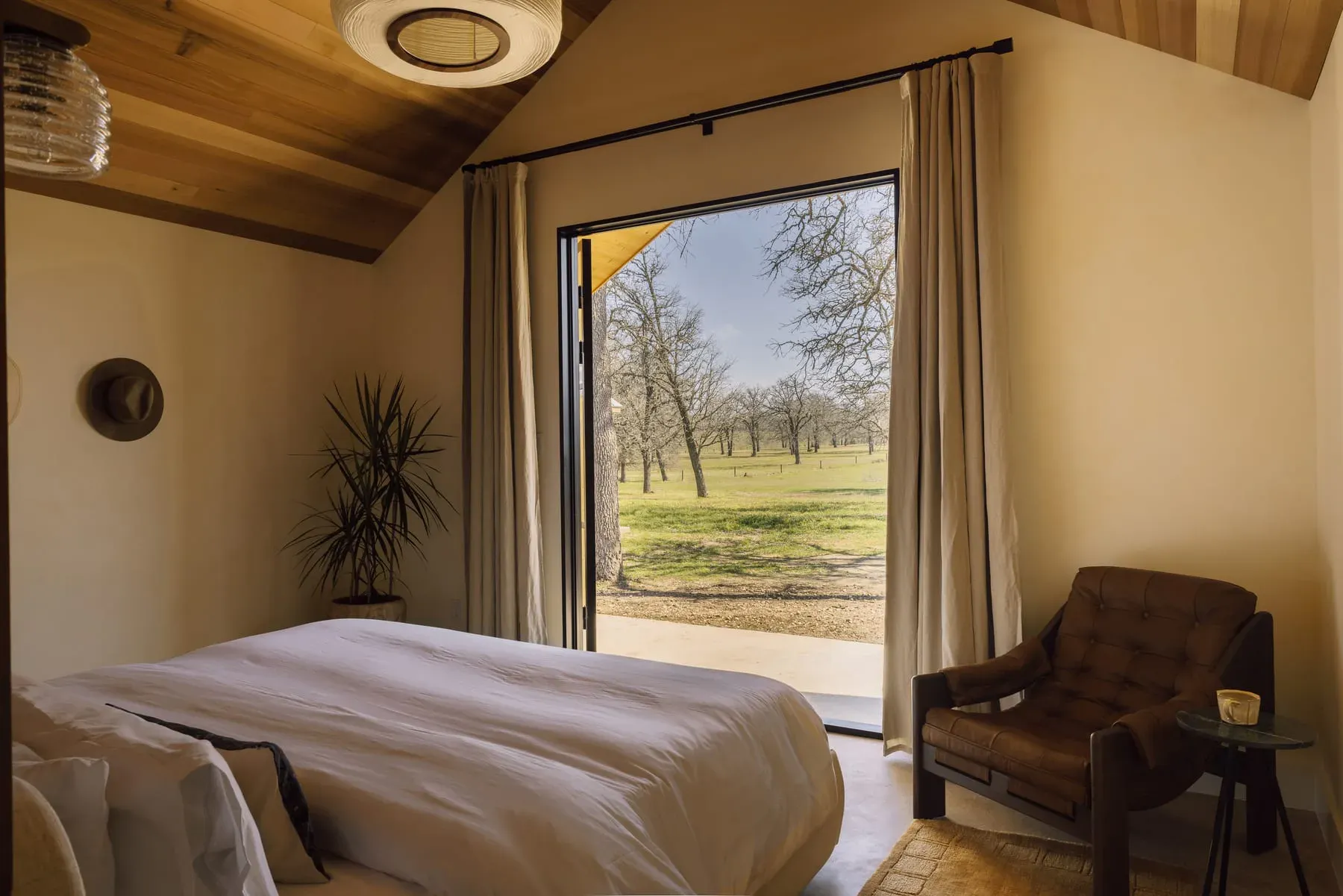 Serana cabin bedroom with window chair and soft bedding