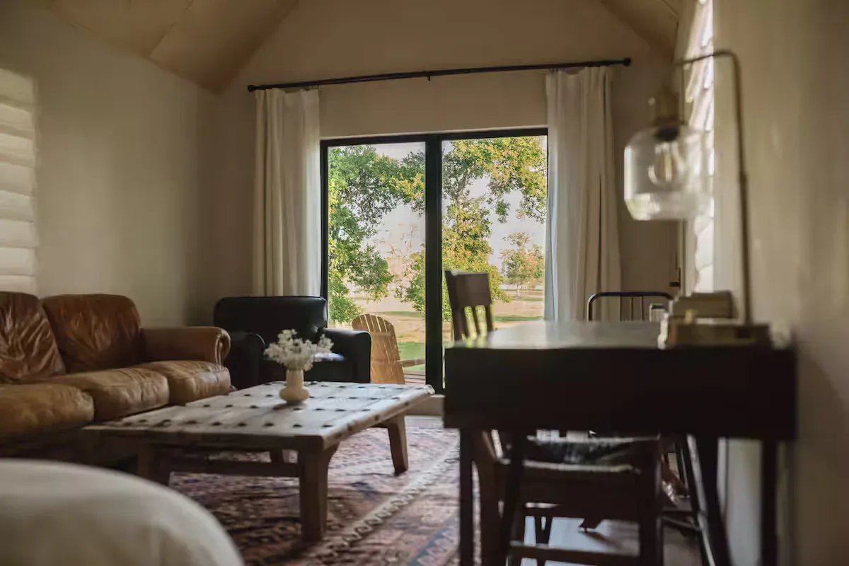 Field Cabin lounge and dining nook beside a window at Serana
